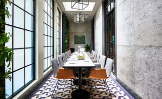 Long dinning table and large windows and beautiful sealing lights