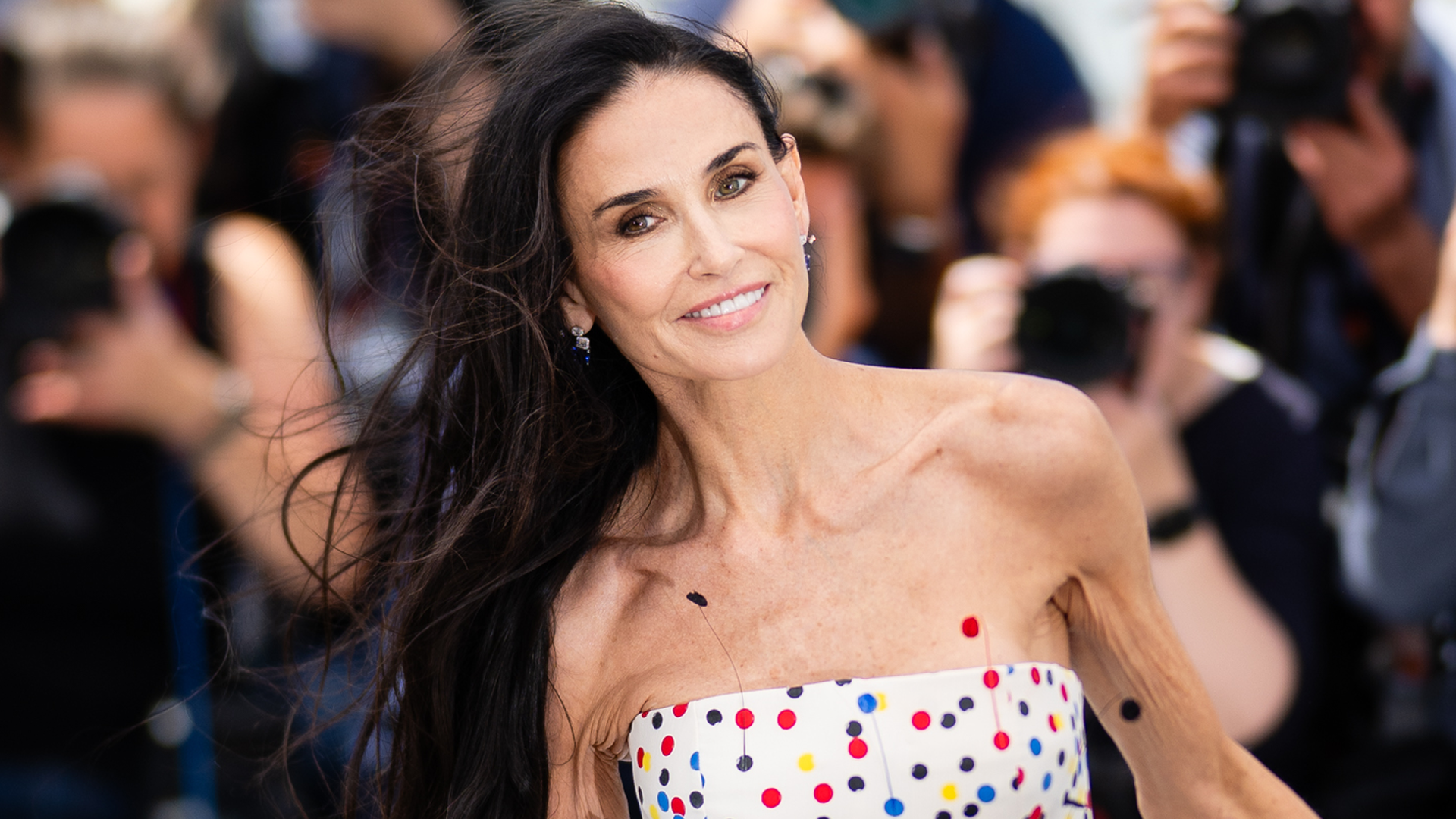 Demi Moore arrived at the 2026 Cannes Film Festival in a multi-color polka-dot little white dress