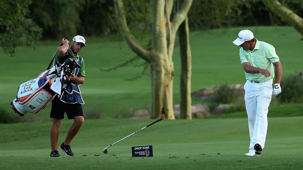 Golfer Darren Fichardt throwing a club