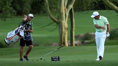 Golfer Darren Fichardt throwing a club