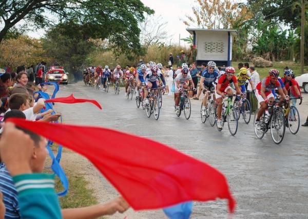 Children cheer as the peloton passes