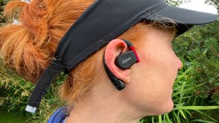 Woman wearing Cleer Arc II Sport headphones