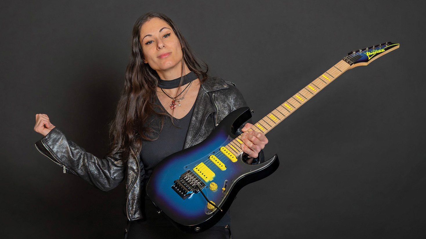 Nili Brosh and her blue Ibanez with yellow pickups