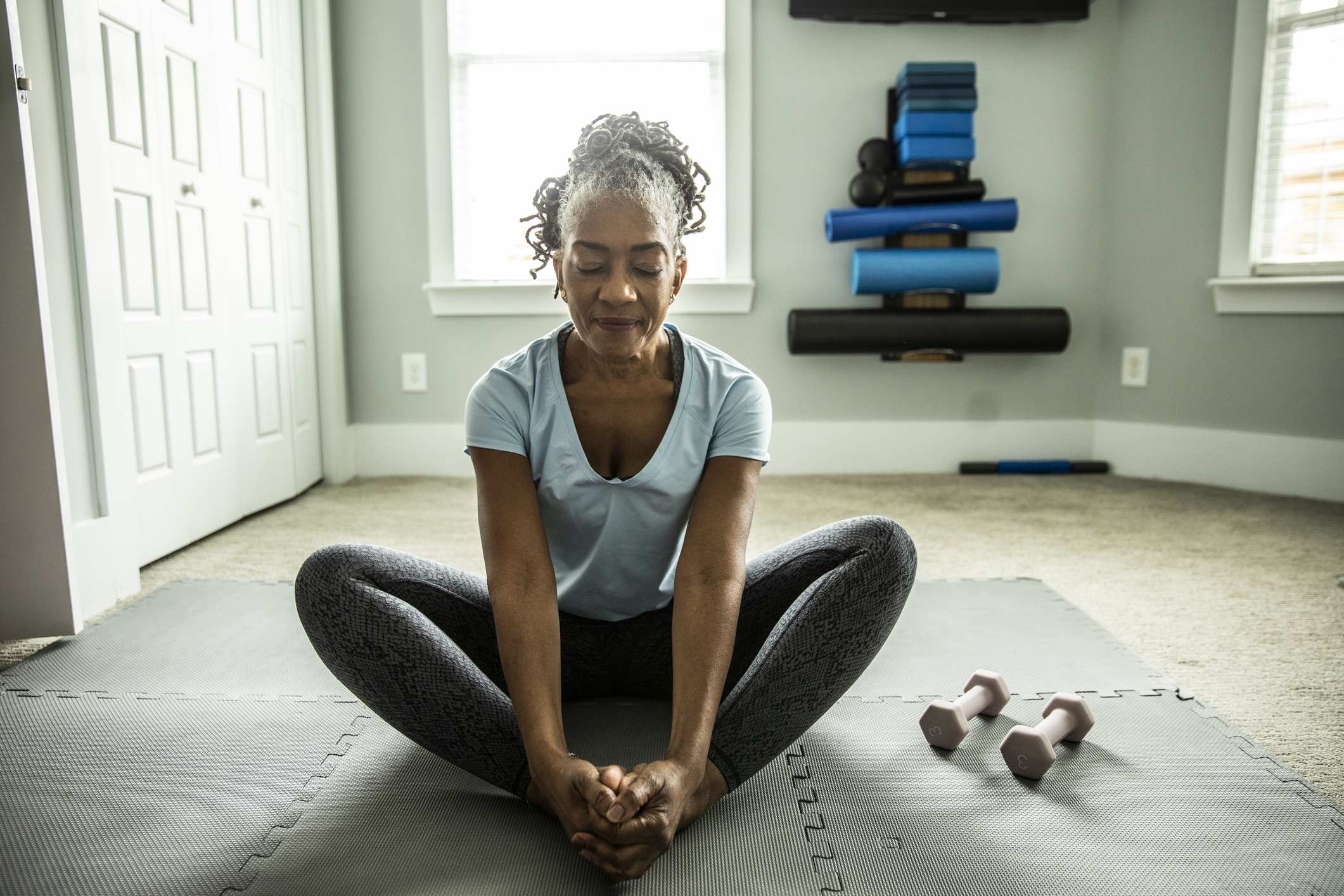 Senior woman exercising in home gym