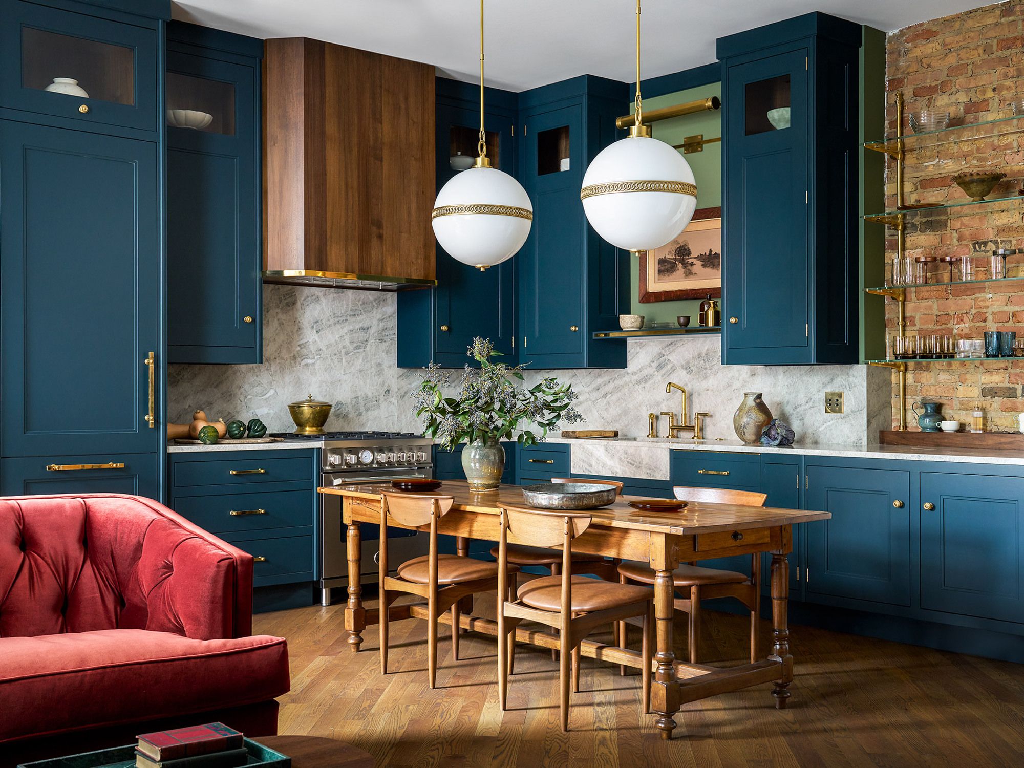 blue teal cupboards with wooden flooring and gold fixtures 