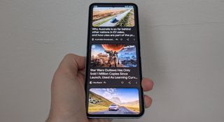 The Samsung Galaxy Z Flip 6 displaying several news articles