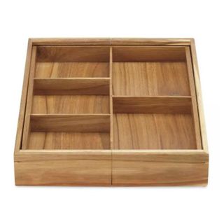 A wooden drawer organizer with five sections