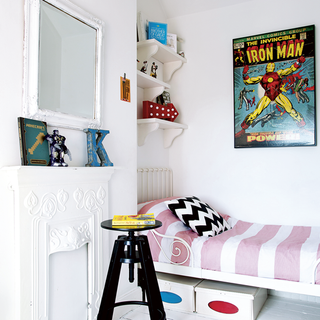 child's white bedroom with walled picture and shelves
