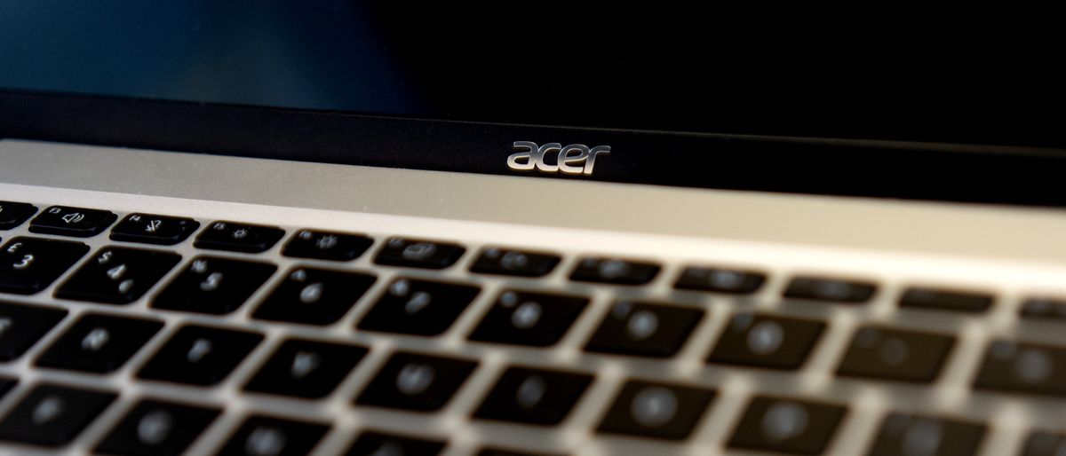 An Acer Swift Go 14 OLED laptop on a black background