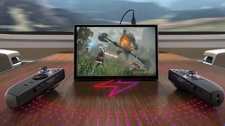 Lenovo Legion Go 2 on train table with controllers detached and charger plugged in with Elden Ring image on screen.