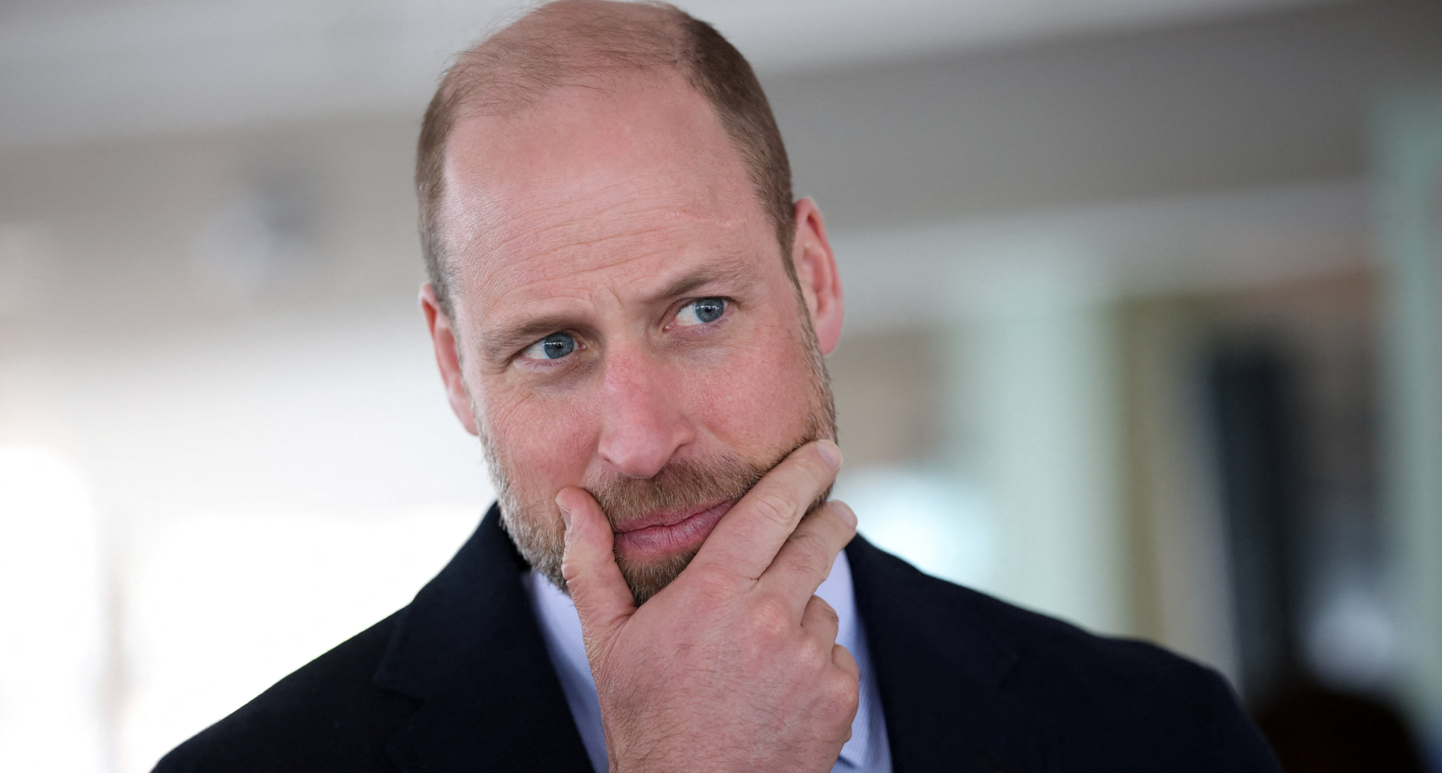 Prince William putting his hand on his chin 