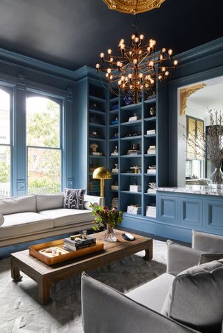 A living room painted blue in a traditional Victorian home on the edge of the Pacific Heights neighborhood of San Francisco