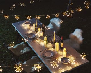 A richlly lit outdoor table at night time