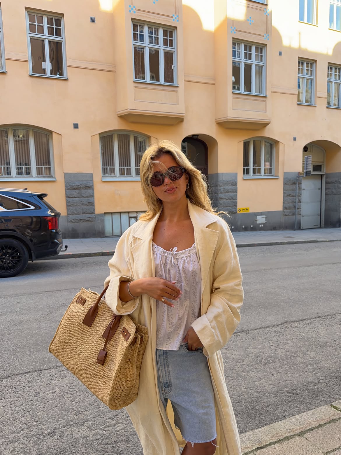Matilda Djerf wearing a white boho top with denim shorts