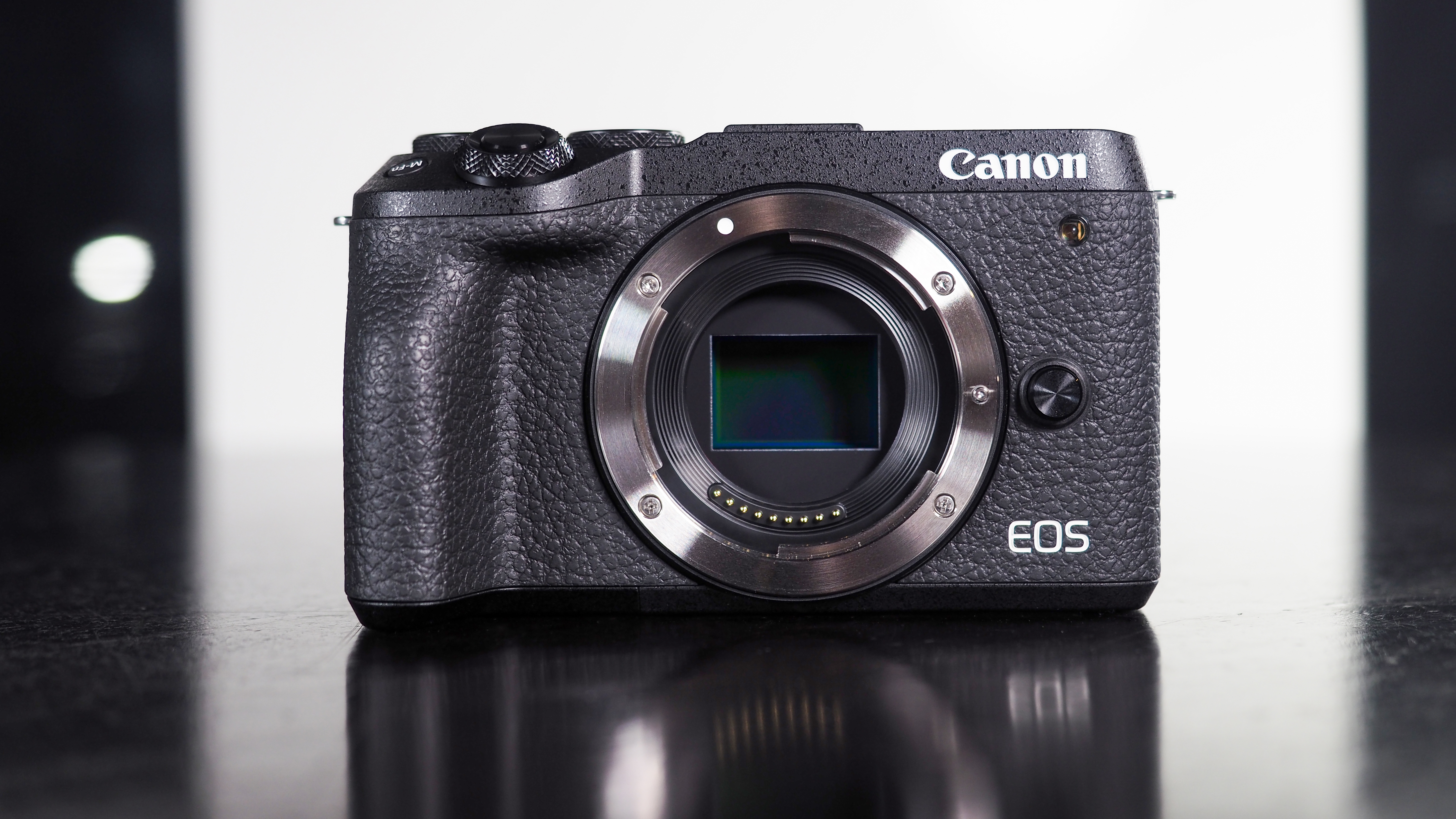 Canon EOS M6 Mark II sitting on a reflective surface