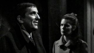 Barnaby and Victoria talking in a dark hallway on Dark Shadows
