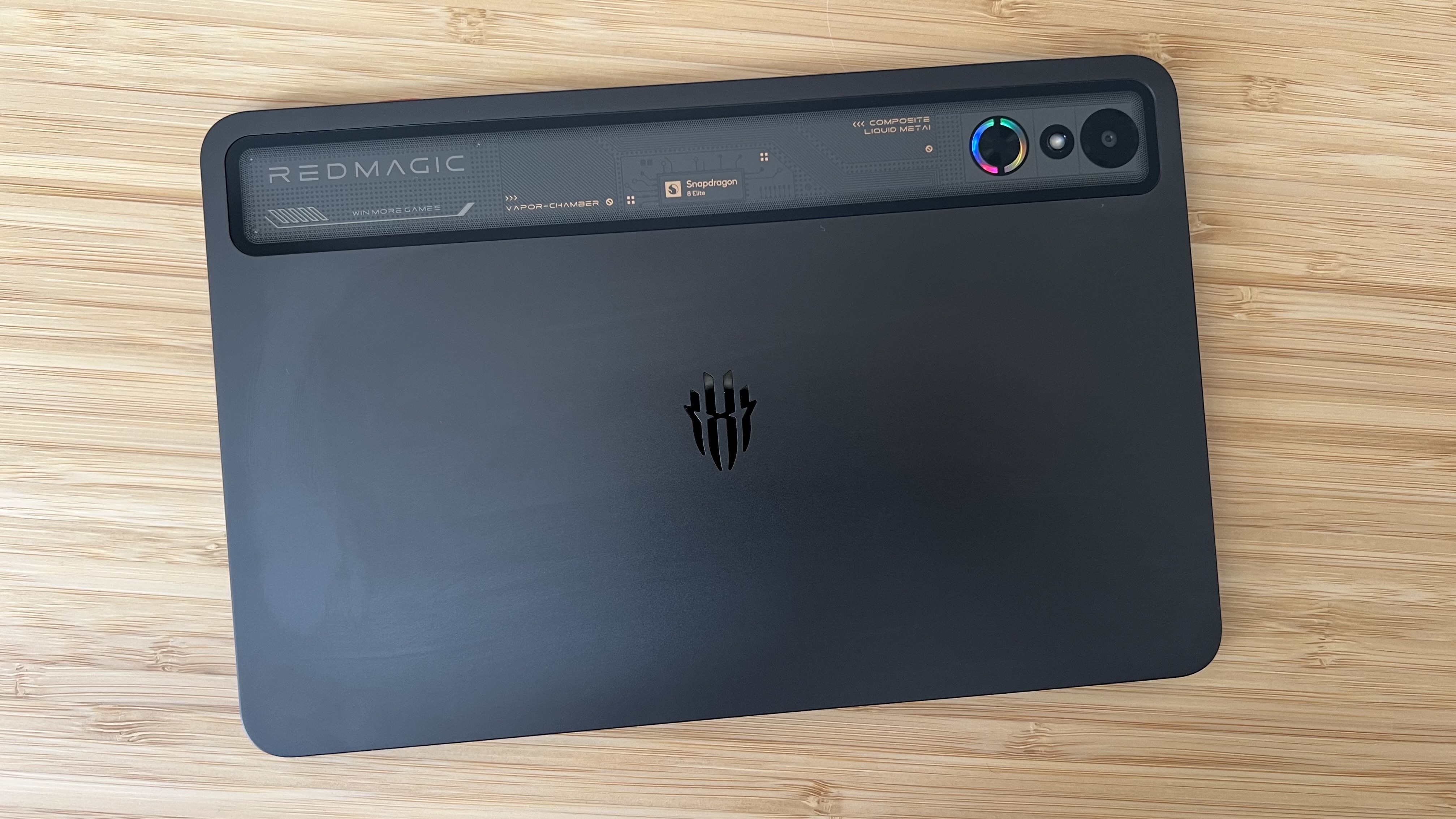 Back panel of RedMagic Astra gaming tablet on a wooden desk