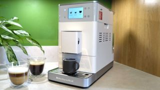 KitchenAid KF4 espresso machine with coffee drinks on kitchen counter