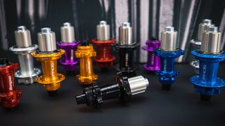 Hope Pro 5 hubs in various colours on a black background 