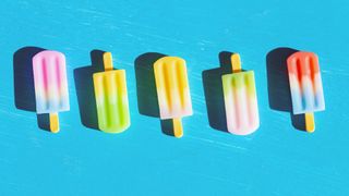 colourful ice lollies sitting on wooden counter