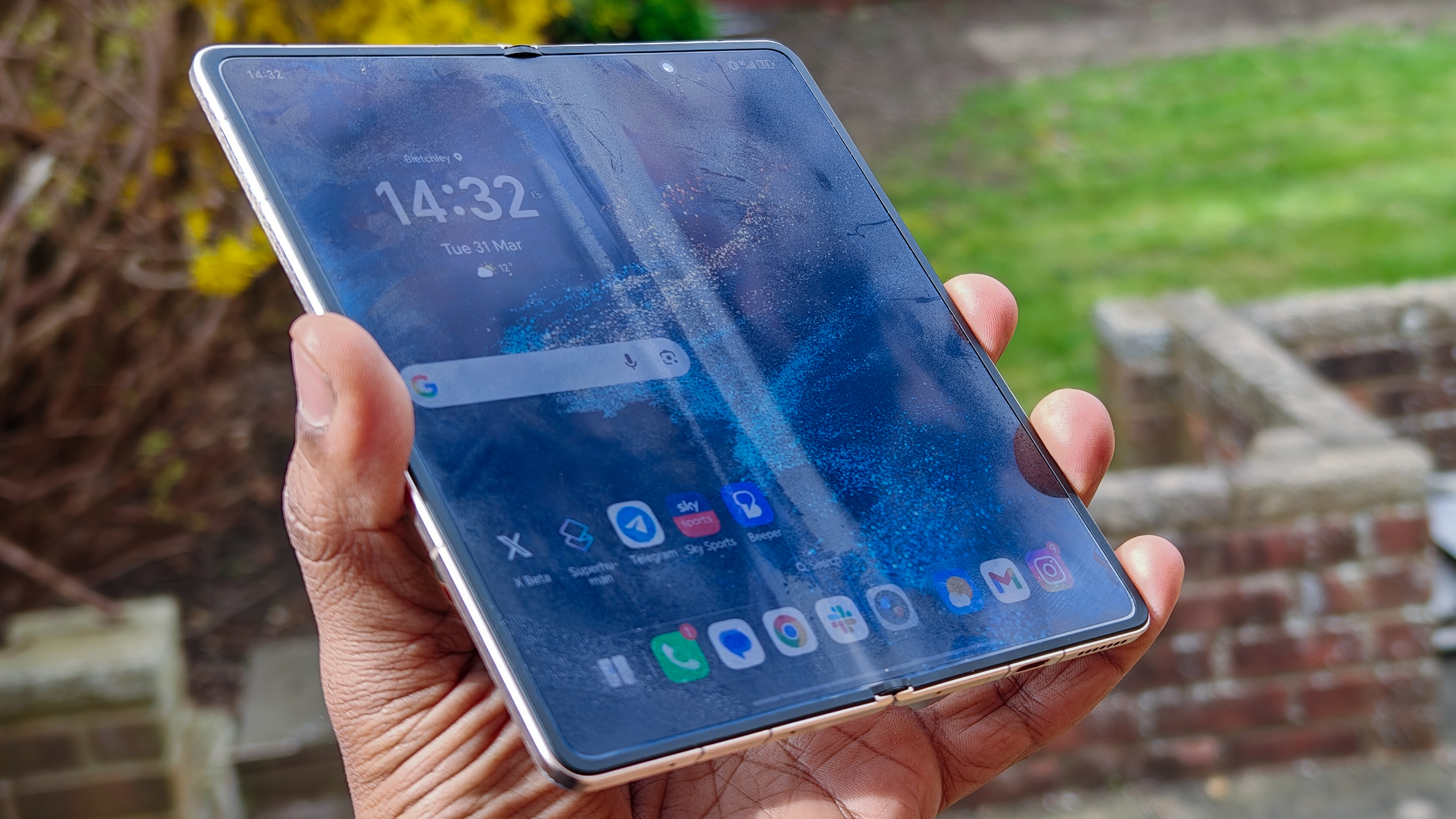 The Honor Magic V6 in gold after being put through a washing machine, complete with scratches and blemishes but fully working. 