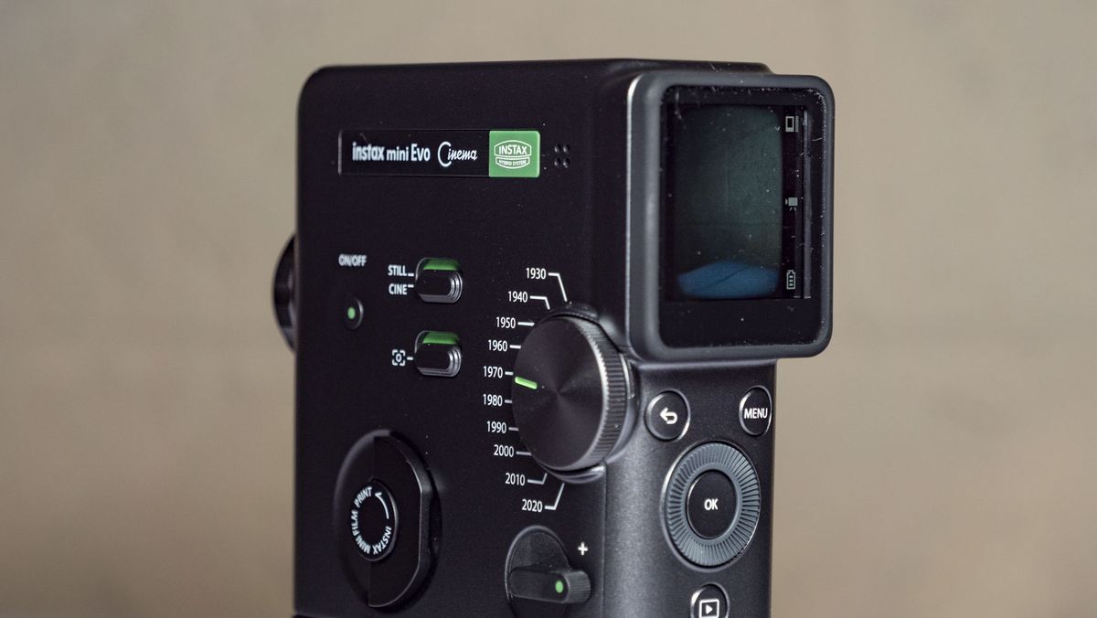 Fujifilm Instax Mini Evo Cinema on a white wooden surface