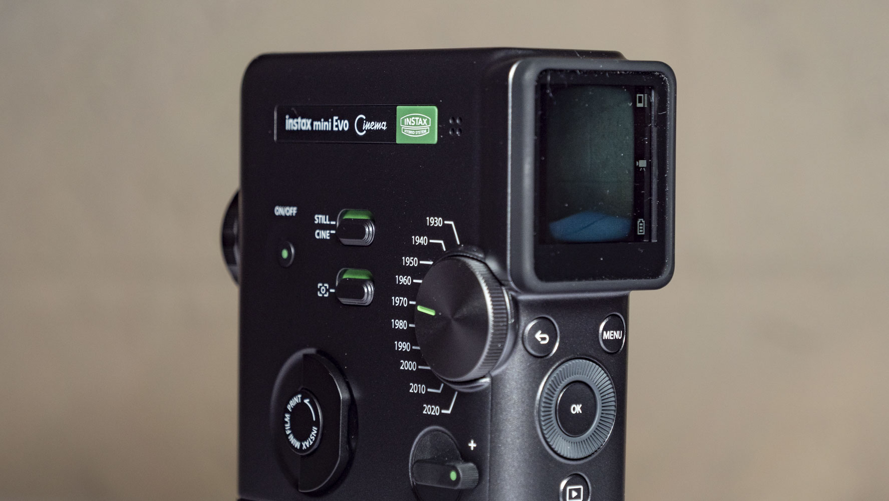 Fujifilm Instax Mini Evo Cinema on a white wooden surface