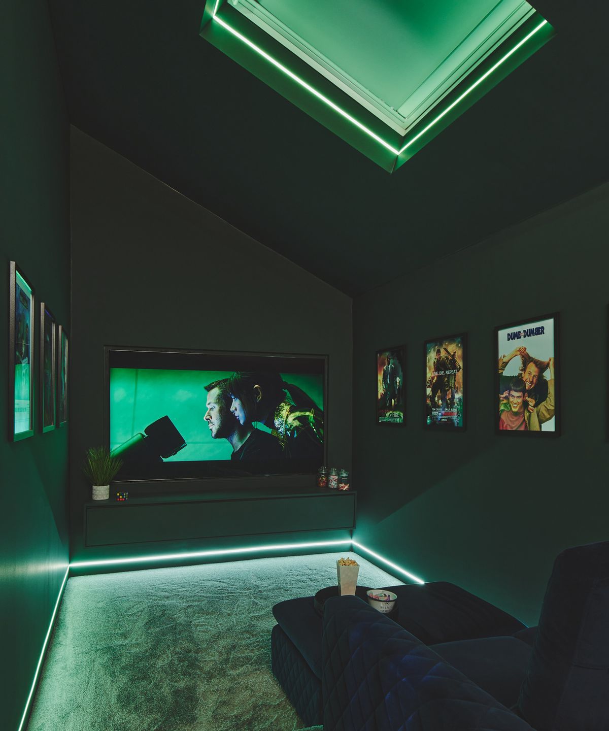 Home cinema room with strip lighting and a comfortable sofa