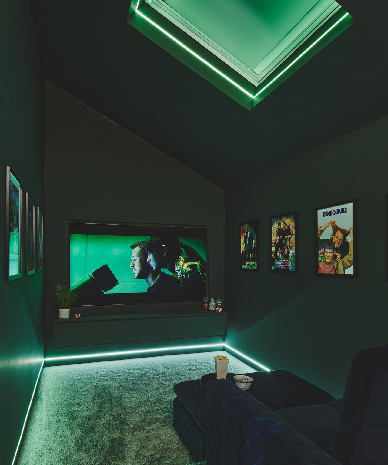 Home cinema room with strip lighting and a comfortable sofa