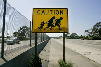 A sign warning motorists to beware of people crossing the road near the U.S. Mexico border in California.