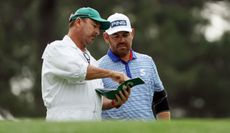 Louis Oosthuizen chats to his caddie during the 2023 Masters