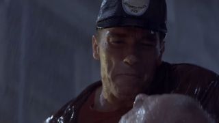 Arnold Schwarzenegger stands in the rain in Last Action Hero