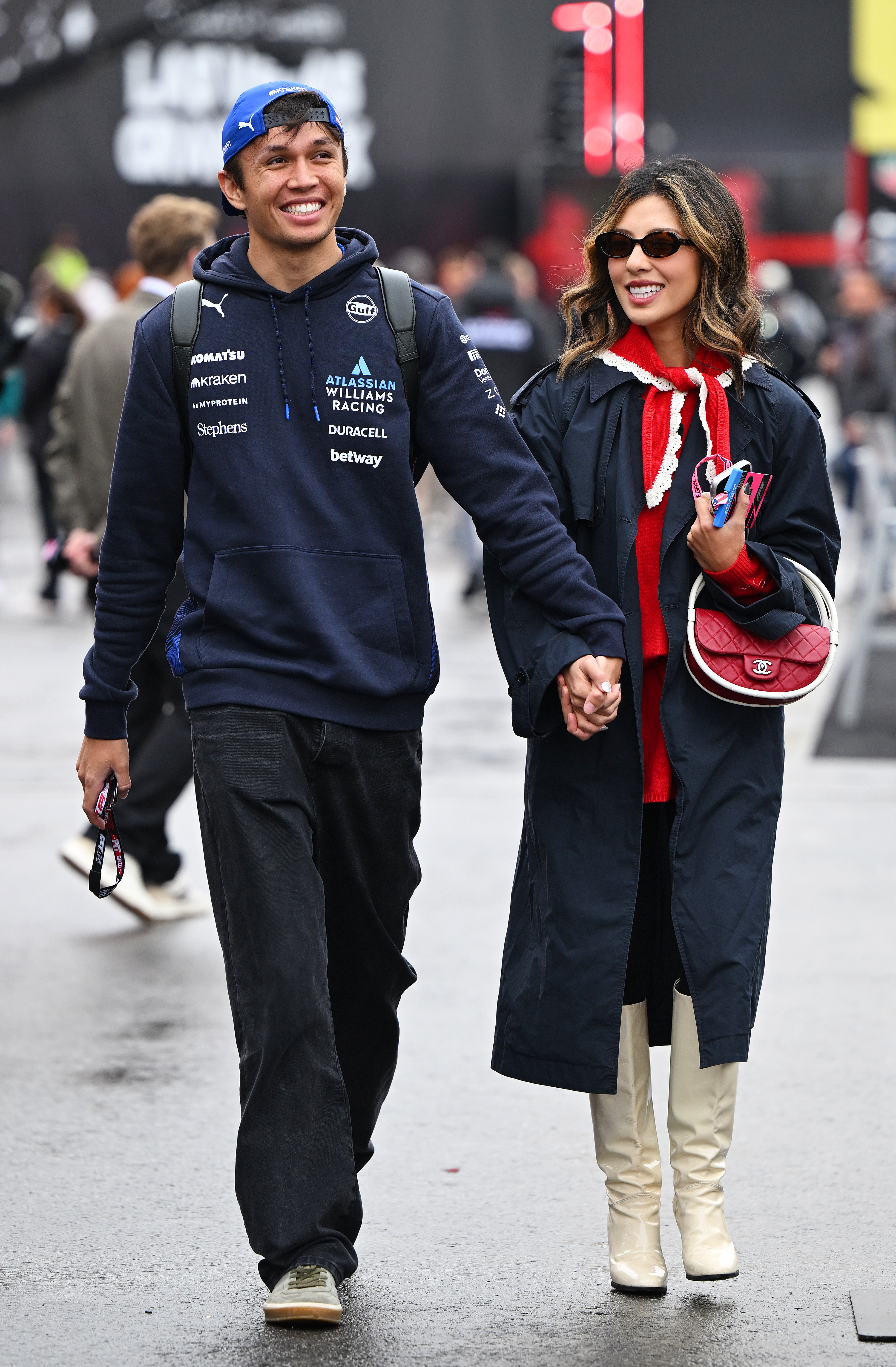 LAS VEGAS, NEVADA - NOVEMBER 21: Alexander Albon of Thailand and Williams and Lily Muni He arrive in the Paddock prior to final practice ahead of the F1 Grand Prix of Las Vegas at Las Vegas Strip Circuit on November 21, 2025 in Las Vegas, Nevada.