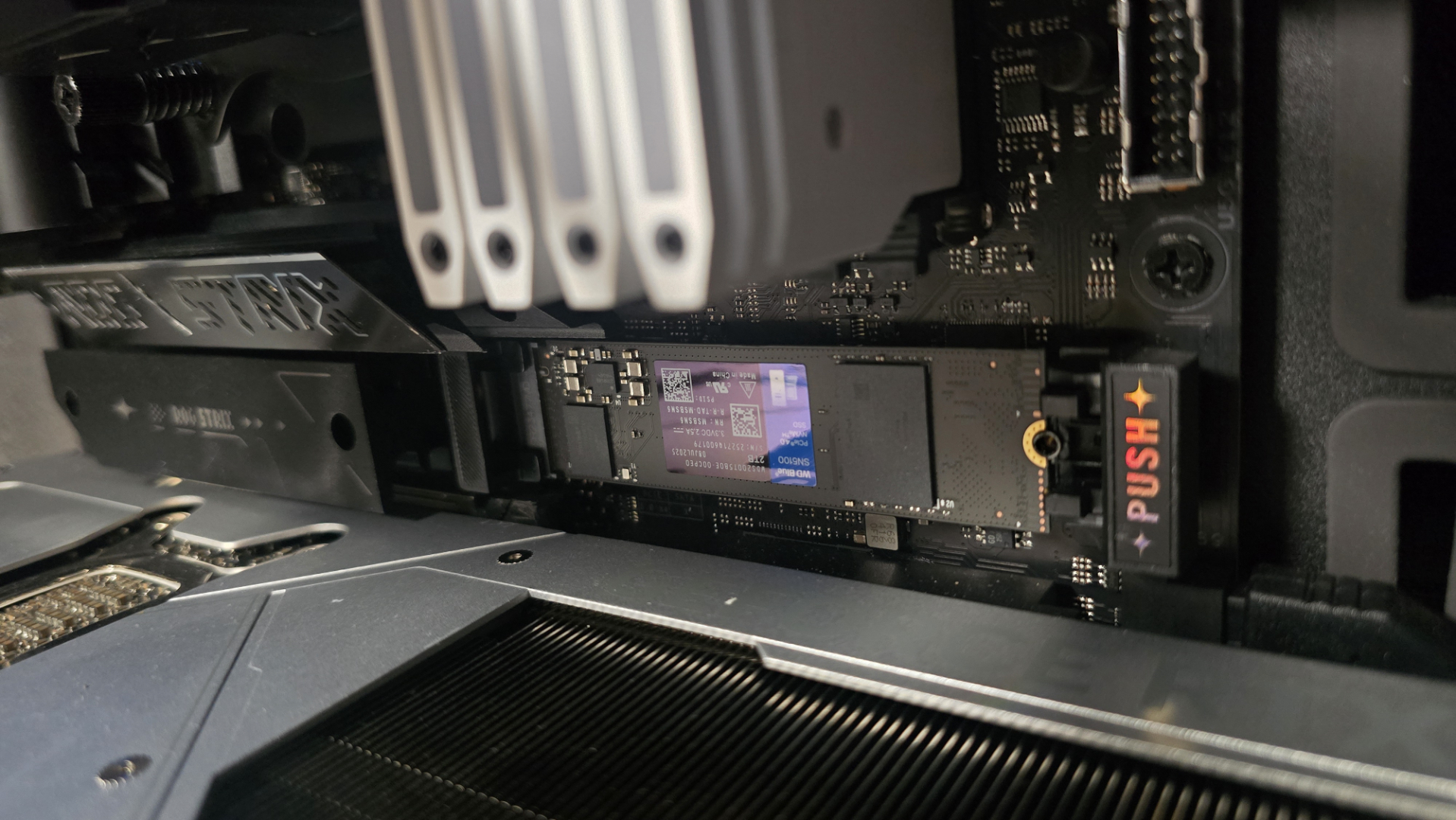 A WD Blue SN5100 ready to be installed inside a gaming PC.