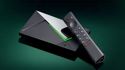Nvidia Shield TV Pro with remote on a dark green background