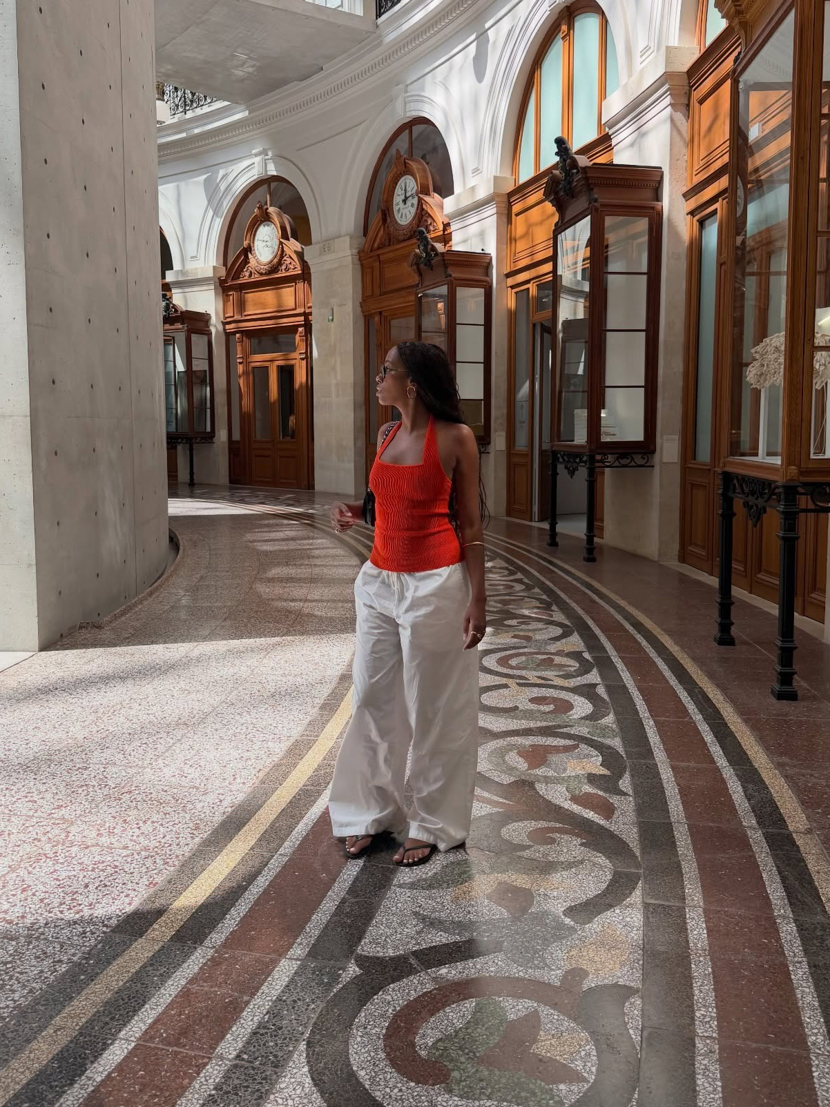 Influencer wearing a tank top, low-rise drawstring pants, and flip-flops