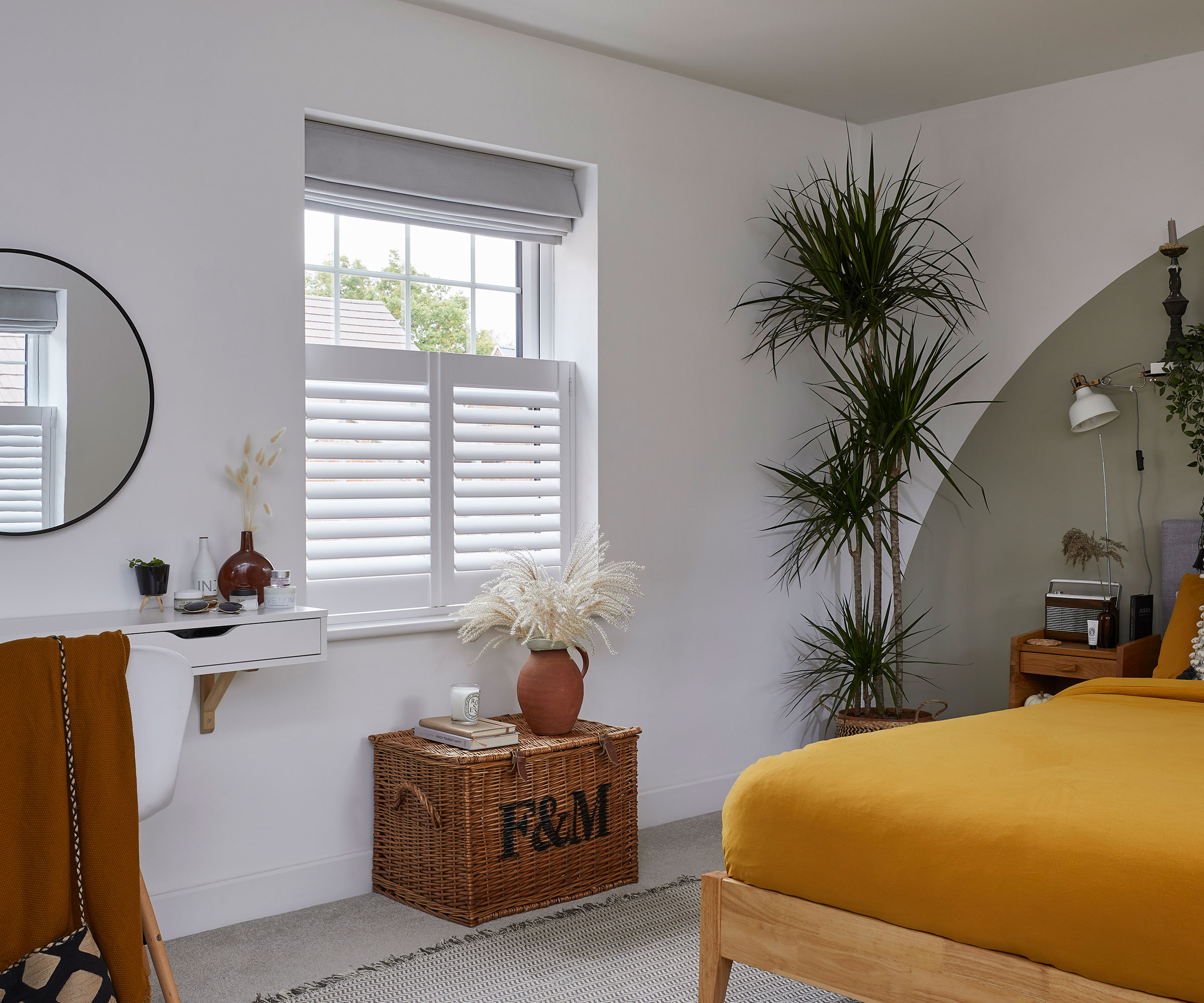 bedroom with sash window with shutters and blind