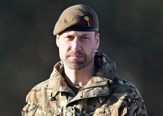 Prince William wearing a camo uniform and green beret