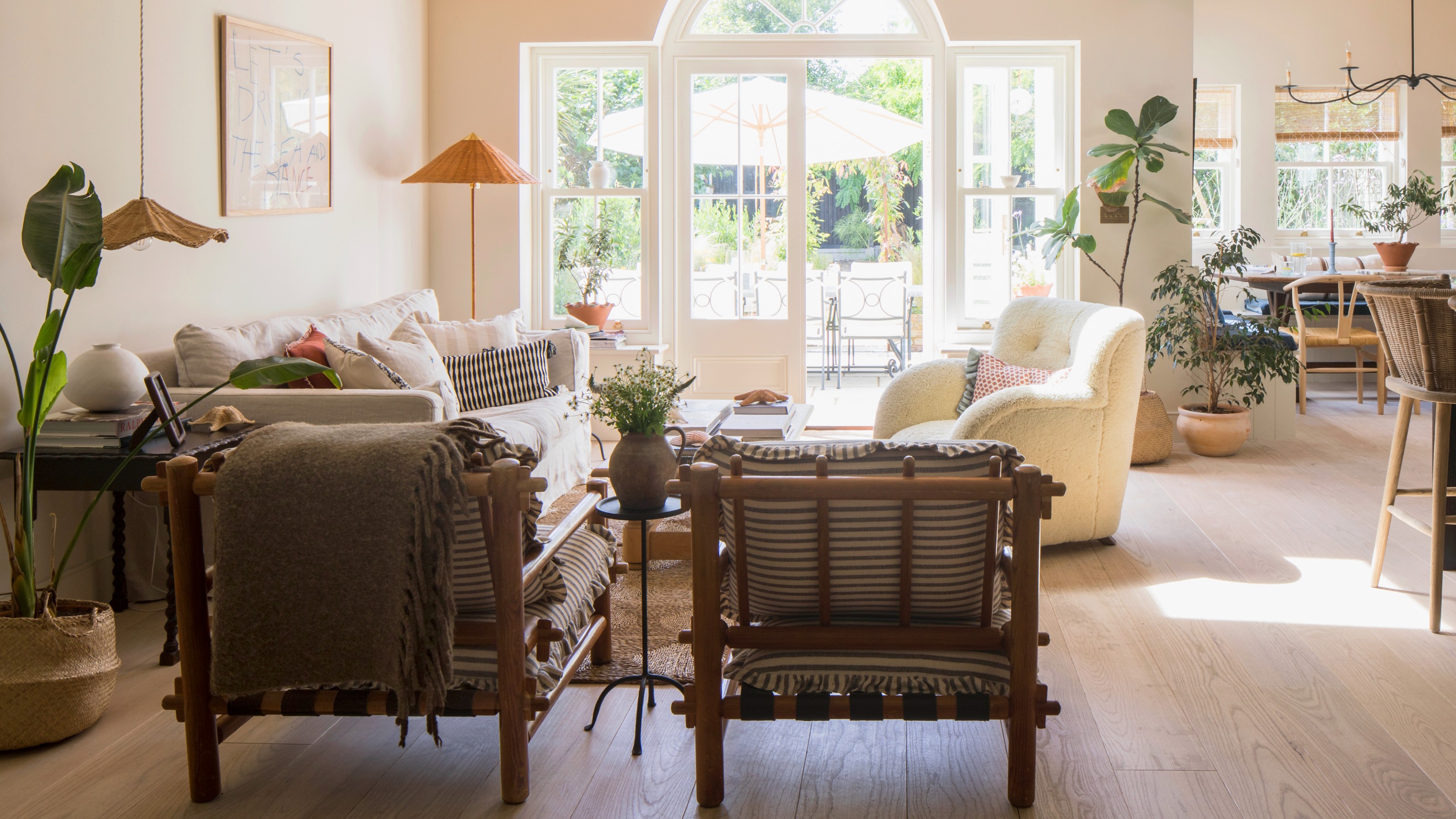 An open-plan living room with high ceilings and a neutral colour scheme