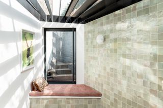 a tiled room with a window seat