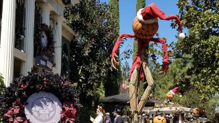 Christmas Jack-o-lantern scarecrow outside Haunted Mansion