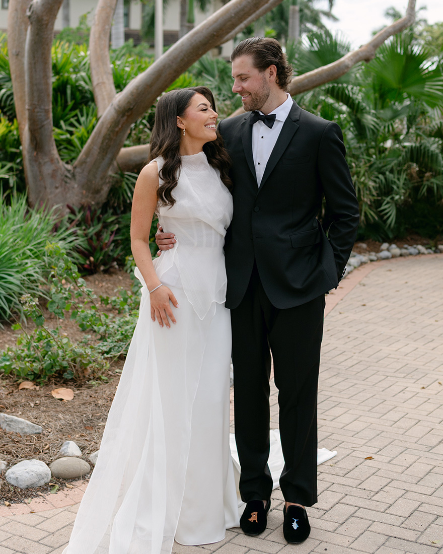 Kelli Orihuela and Chris Denci in their wedding outfits during the first look.