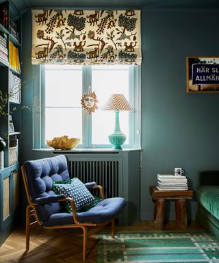 blue bedroom with an embroidered blind and unique vintage decor pieces
