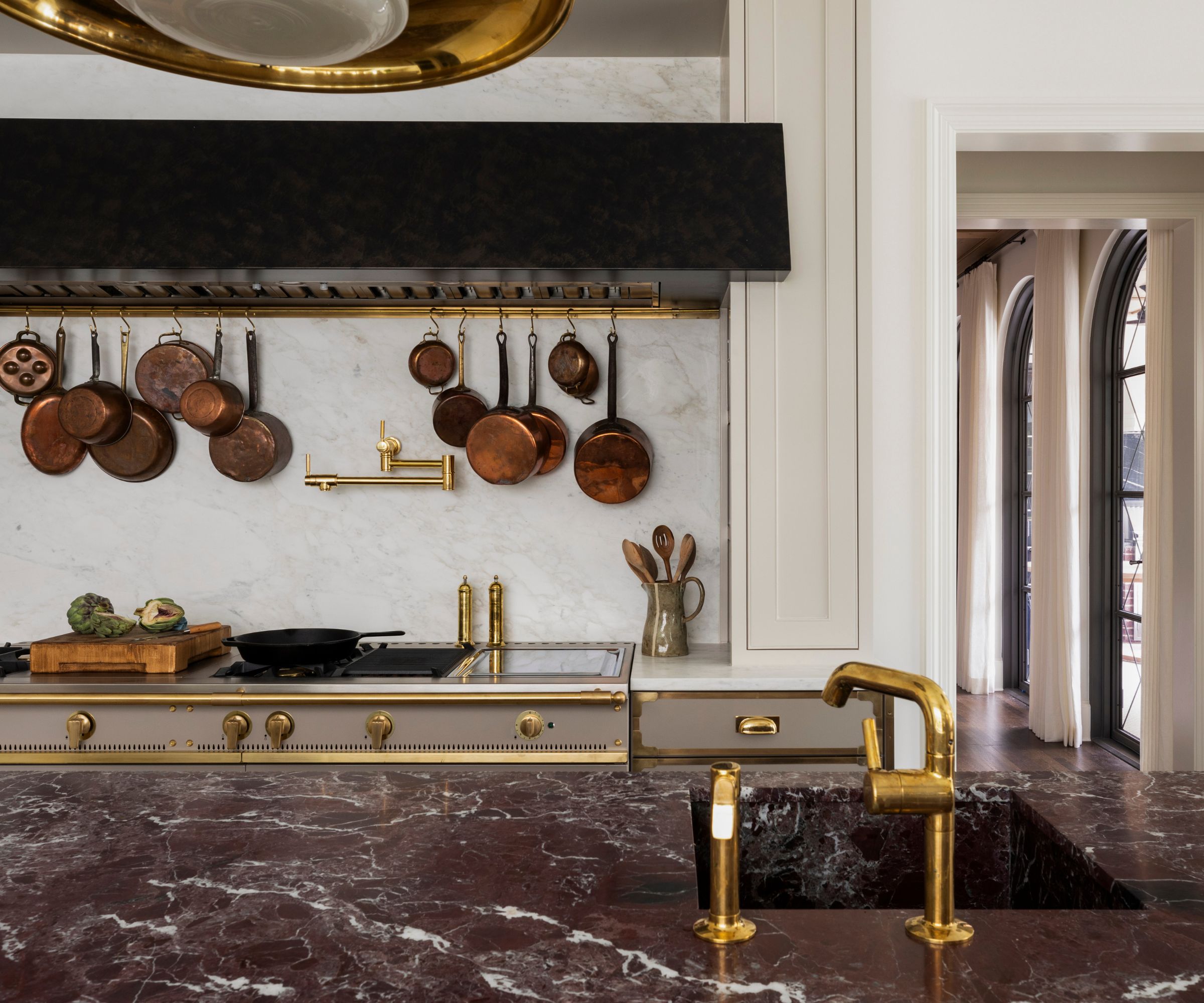 A traditional kitchen with burgundy marble countertops and sink