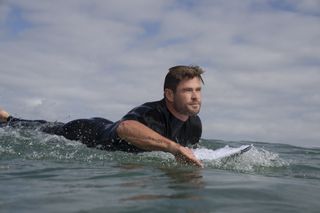 Surfing fan Chris Hemsworth has felt the presence of sharks while out on the ocean.