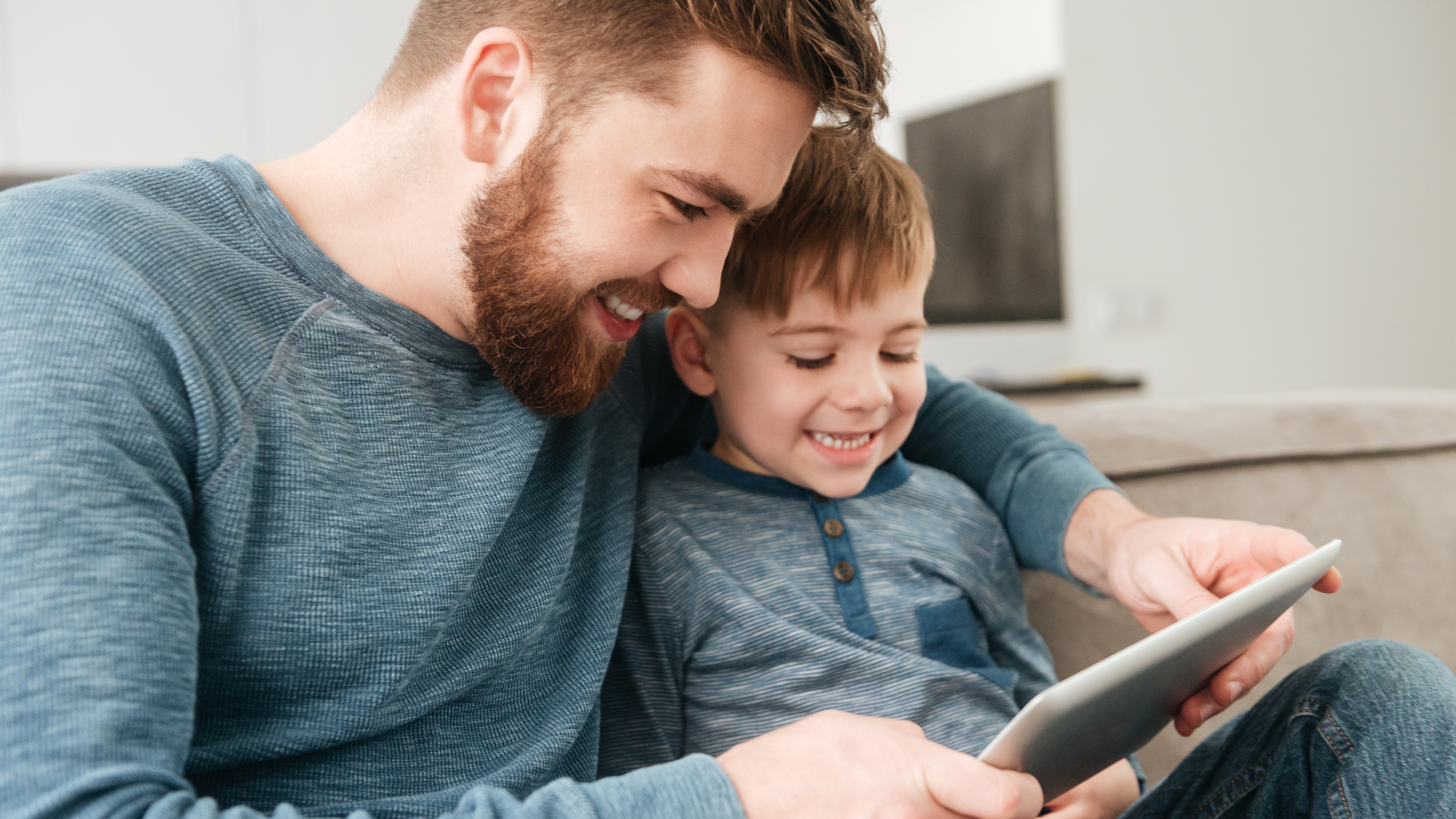 Father and child with tablet