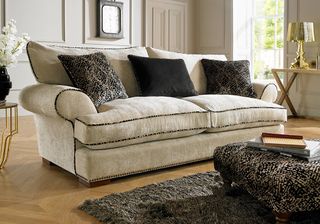 living room with four seater sofa and footrest