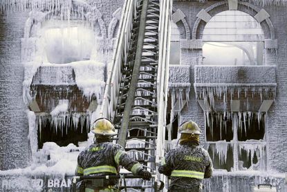 Ice covers a building that was on fire.
