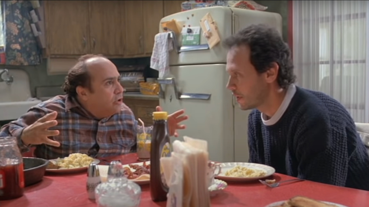 Danny DeVito talks with Billy Crystal at the breakfast table in Throw Momma From The Train.