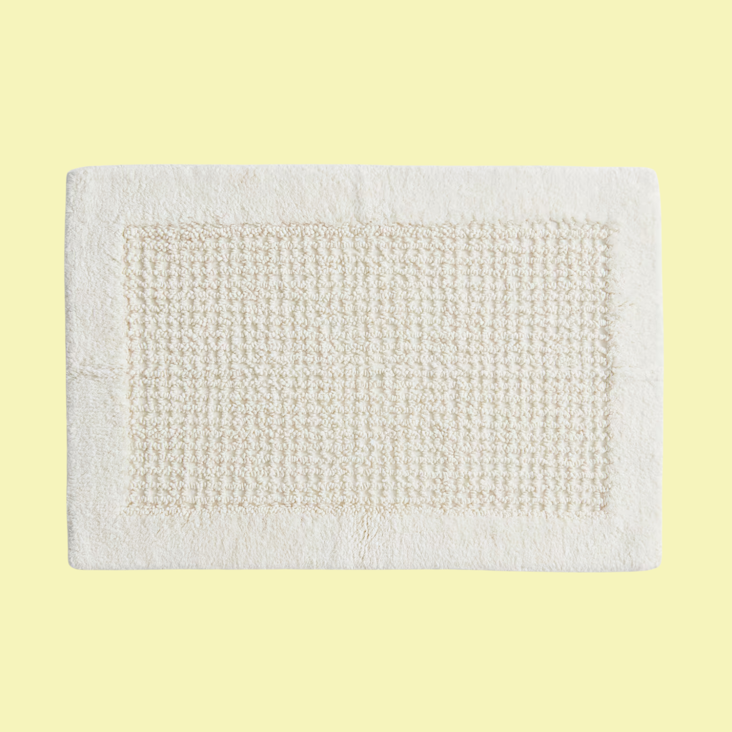 A tufted cotton bath mat